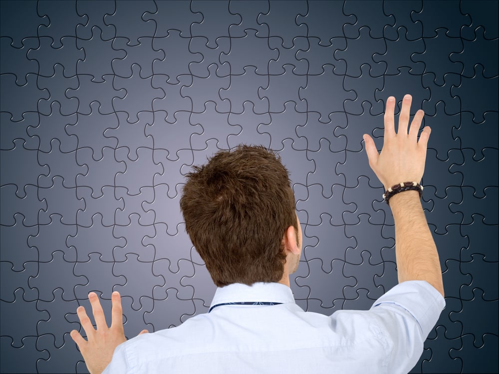 Business man with a black jigsaw puzzle